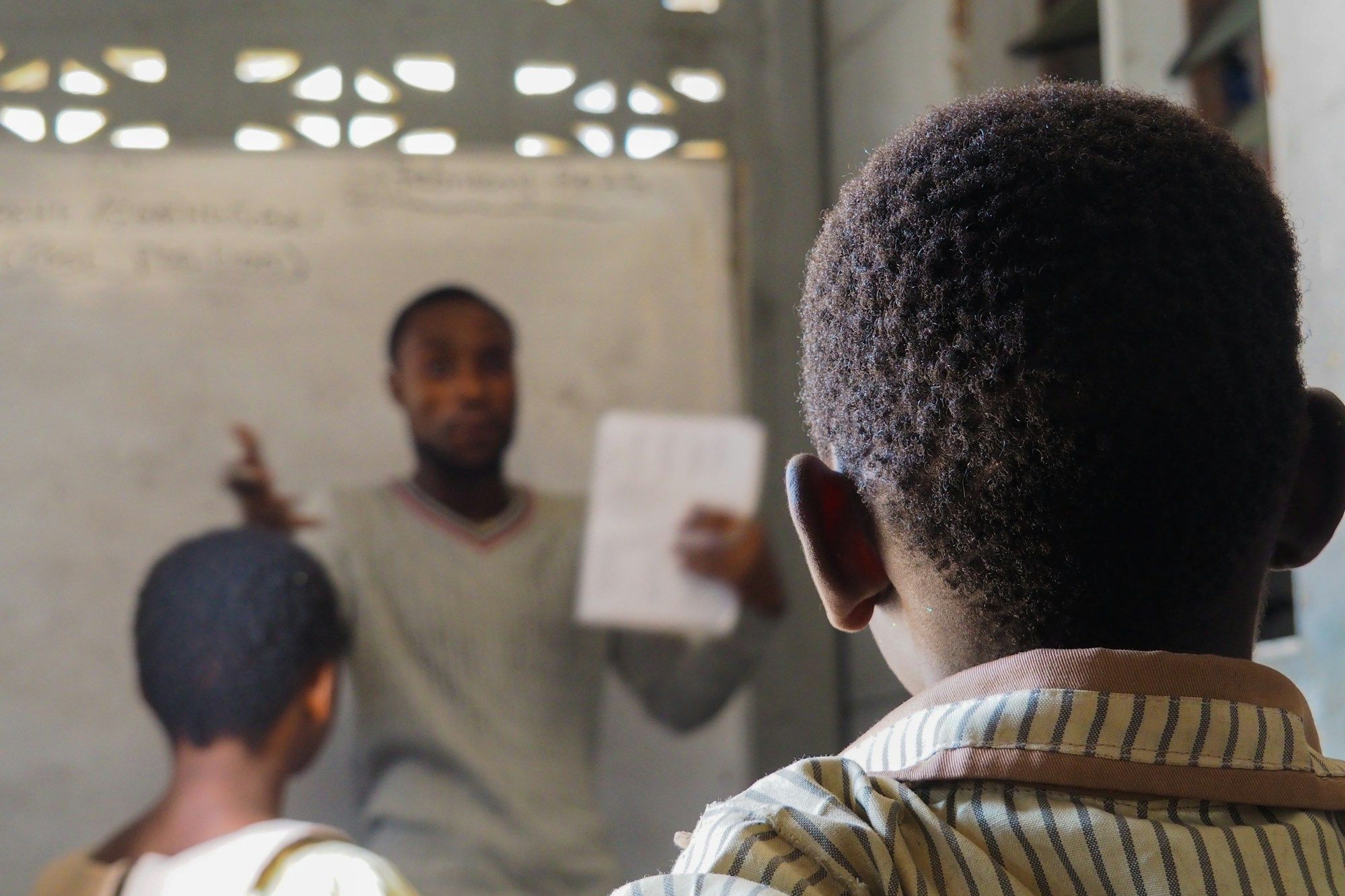 A teacher instructs students in a classroom