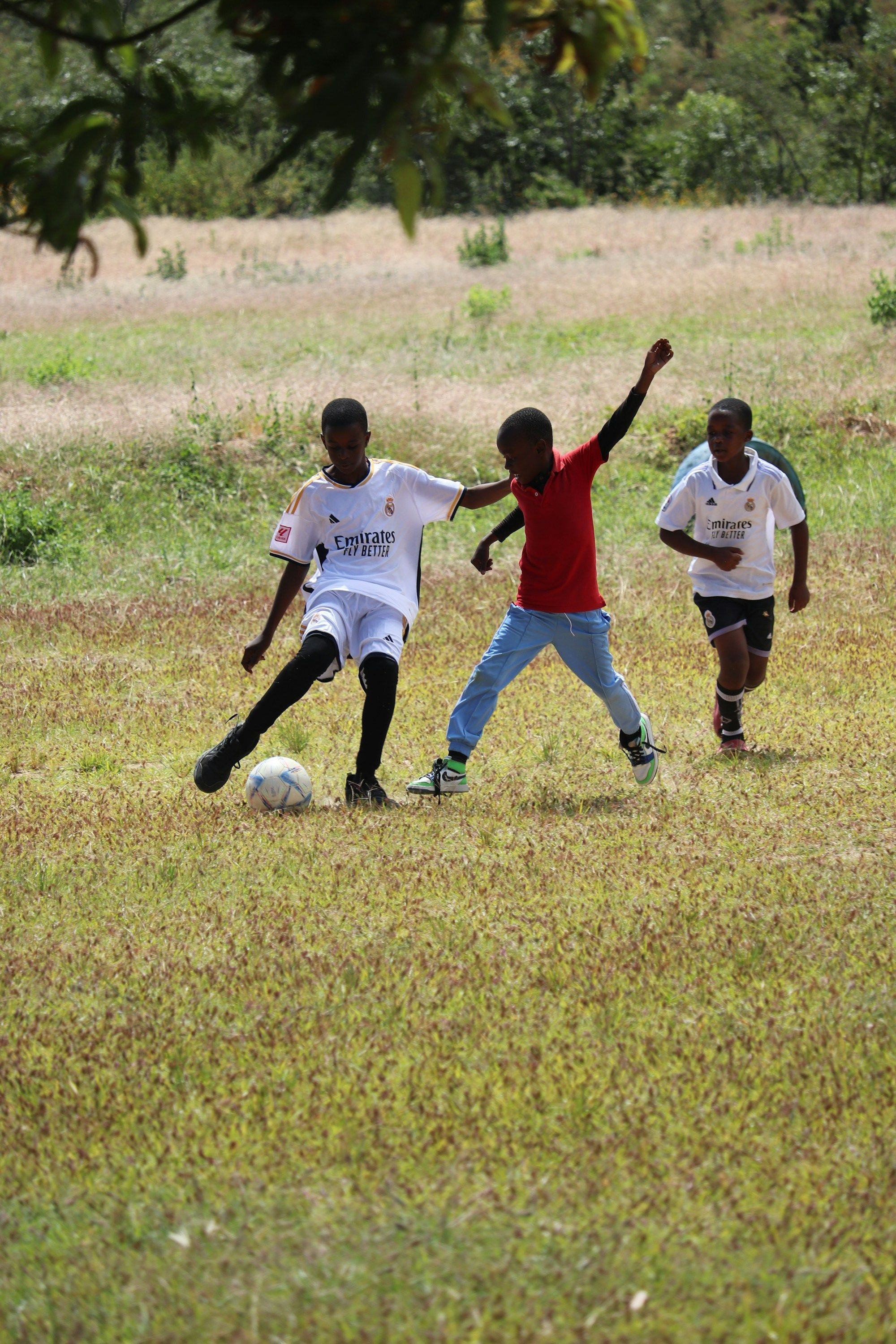 Young boys playing football on a grassy field