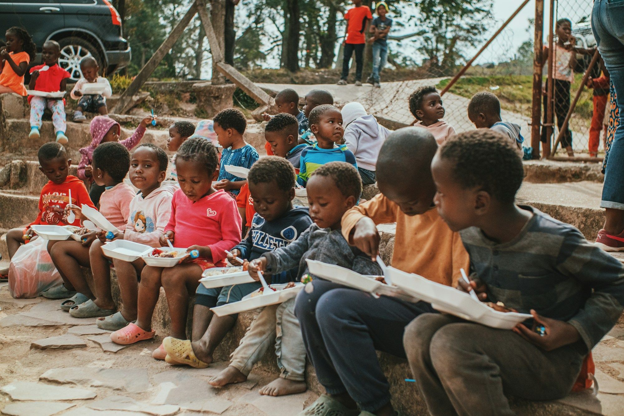 Children sitting on steps with books