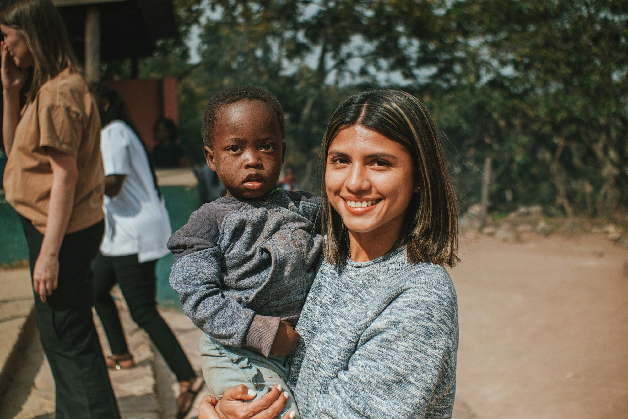 A teacher holding a young child