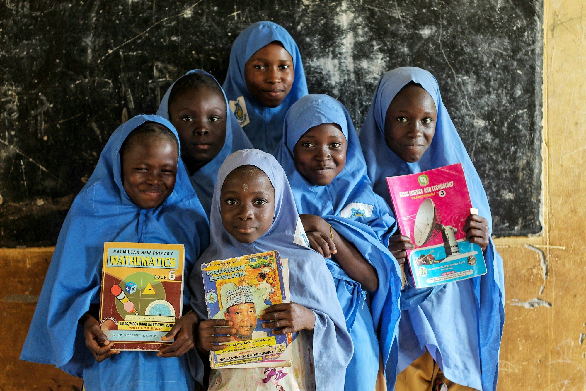 A group of students holding books